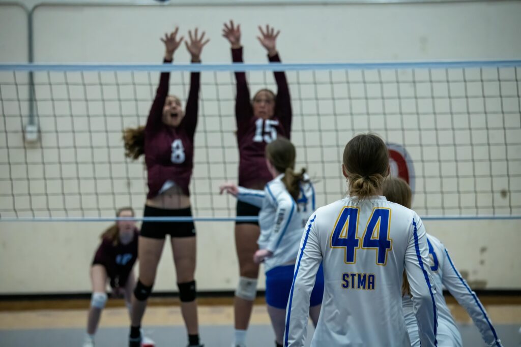 Players in action during a high school volleyball match in Rochester, MN.